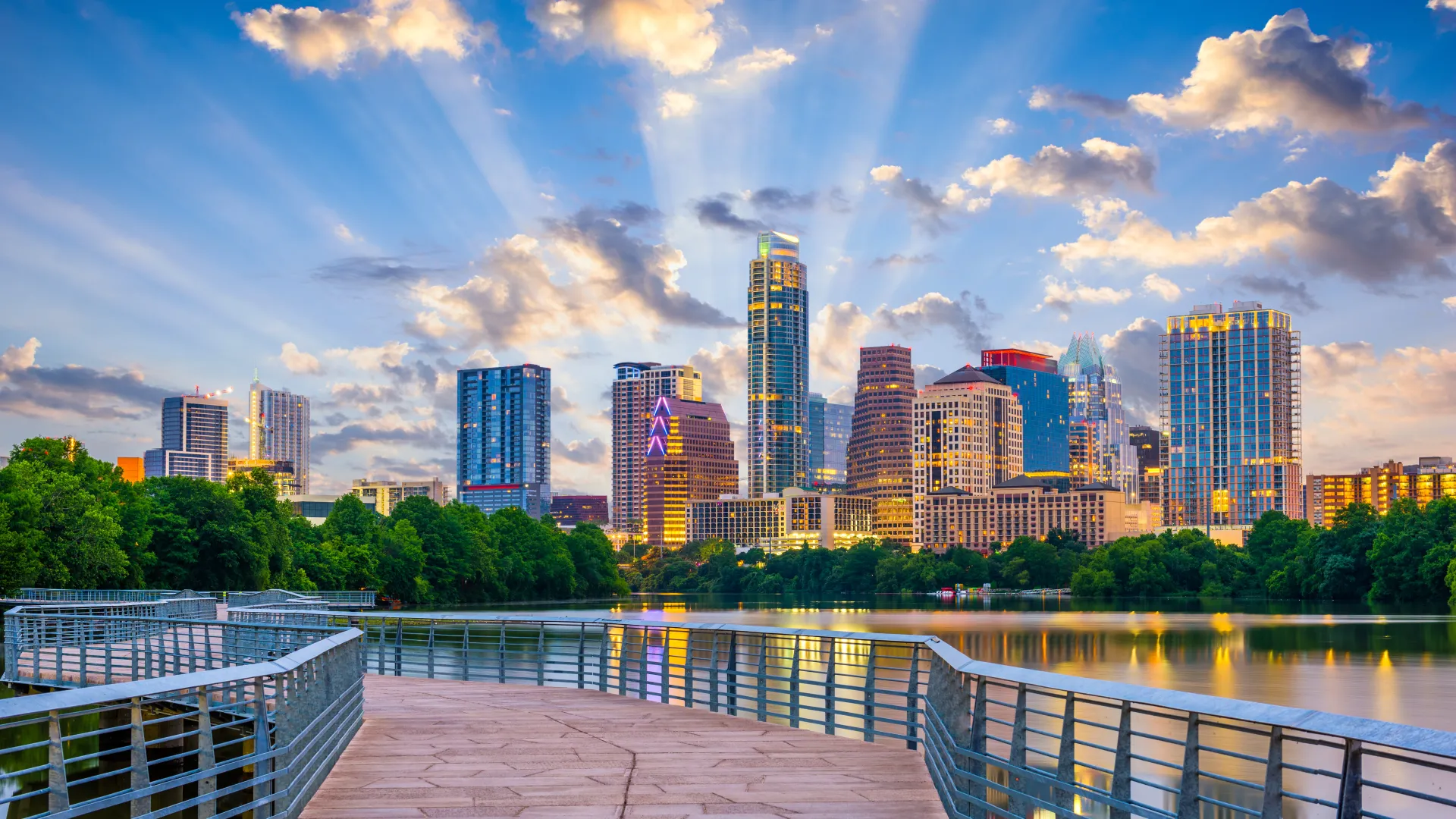 a city skyline with a body of water in front of it