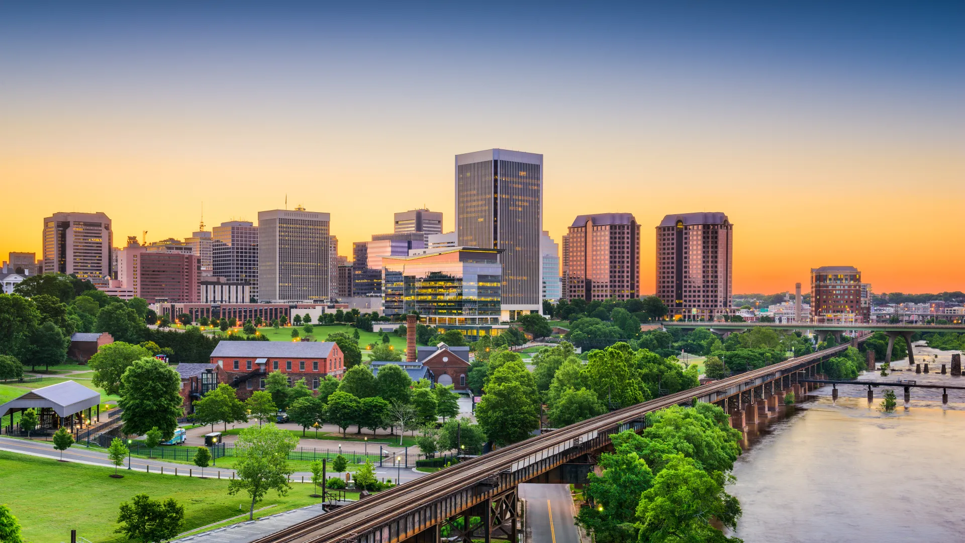 a bridge over a river with a city in the background