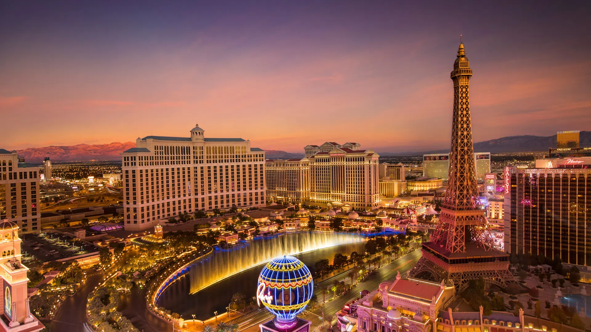 Las Vegas Strip at sunset featuring Paris Hotel's Eiffel Tower replica and Bellagio fountains in vibrant cityscape.