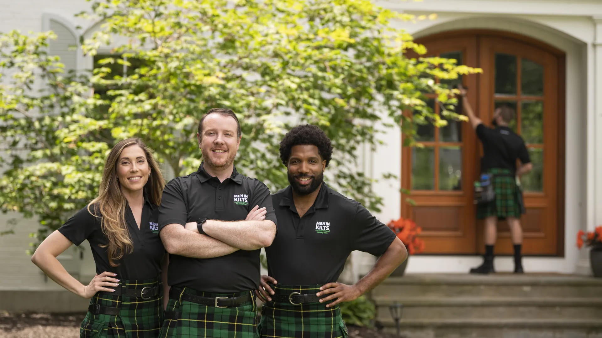 A group of people in kilts posing for a photo