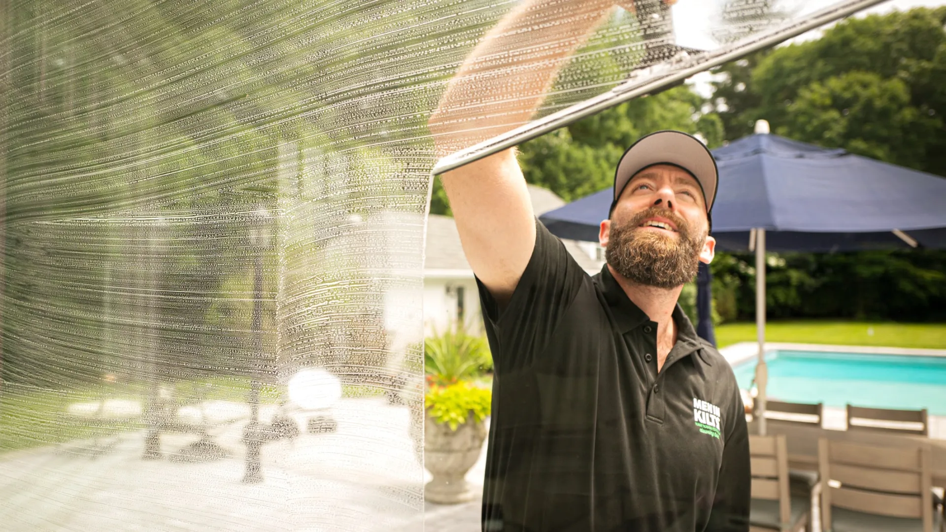 a man with a beard washing a window