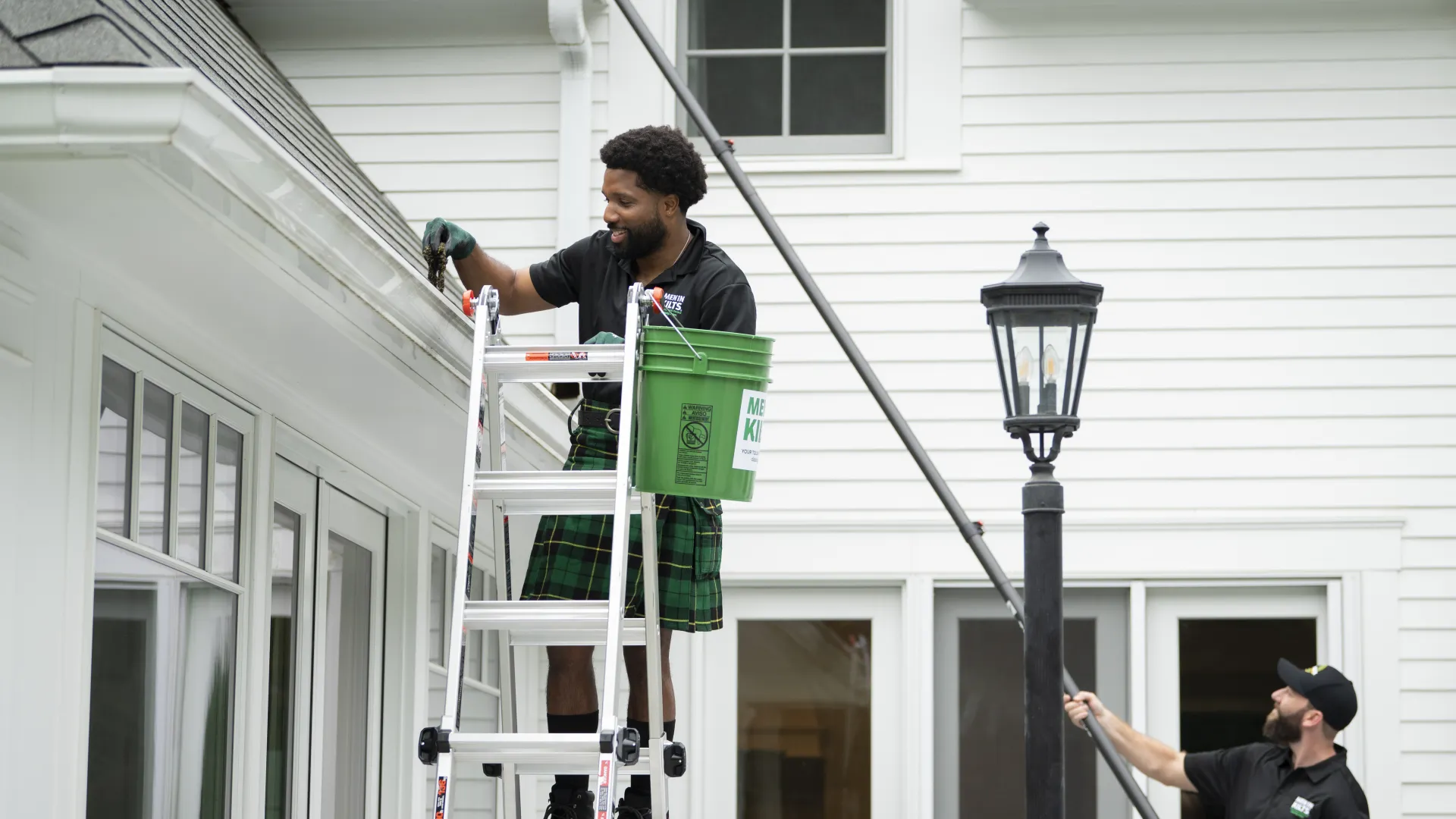 a man on a ladder holding a box