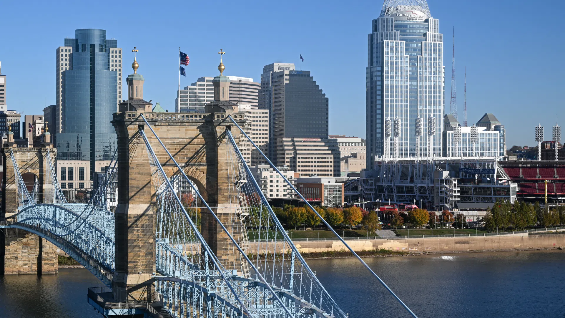 John A. Roebling Suspension Bridge over the Ohio River with Cincinnati skyline and Great American Tower on sunny day