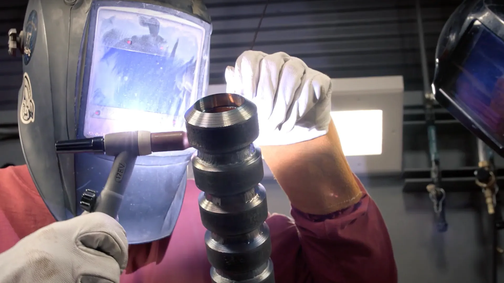 a person wearing gloves and gloves holding a microscope