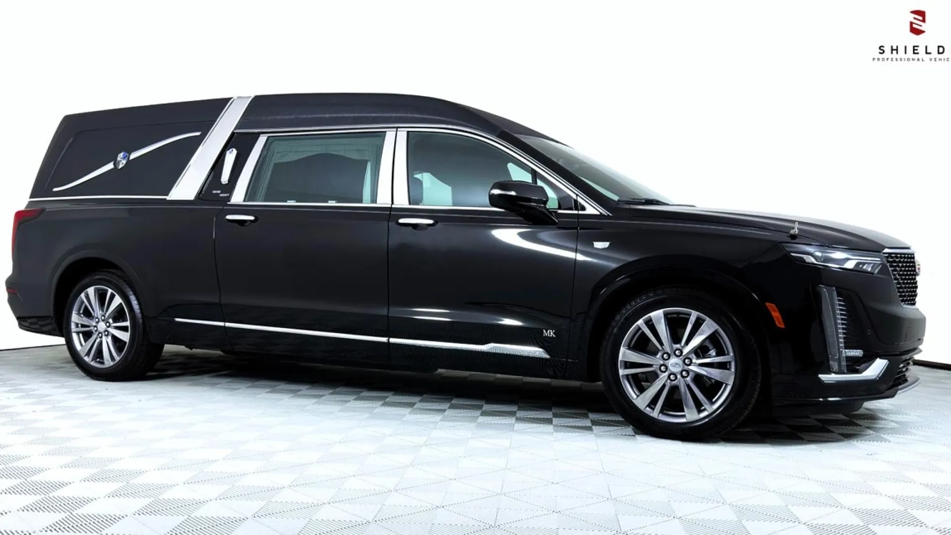 A sleek black luxury hearse with elegant design features and smooth lines.