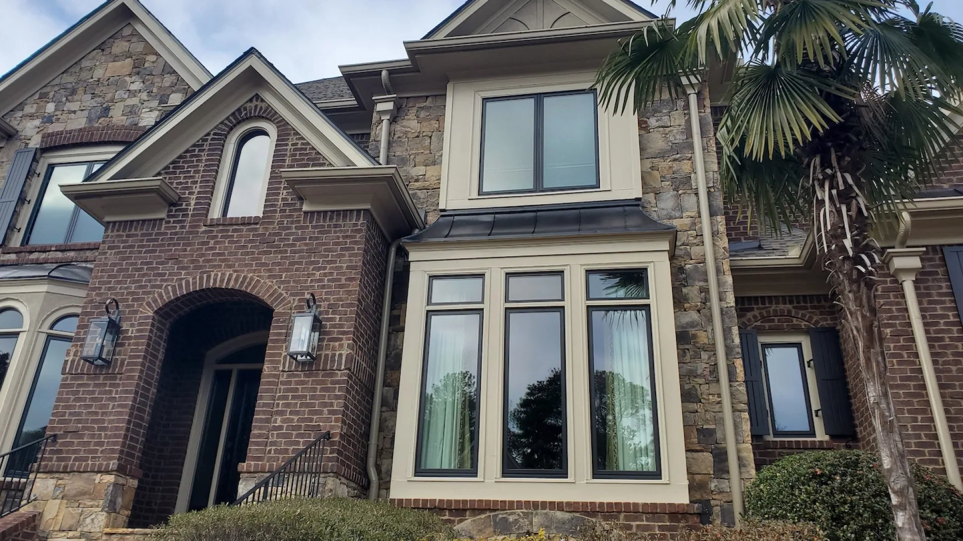 a brick house with palm trees