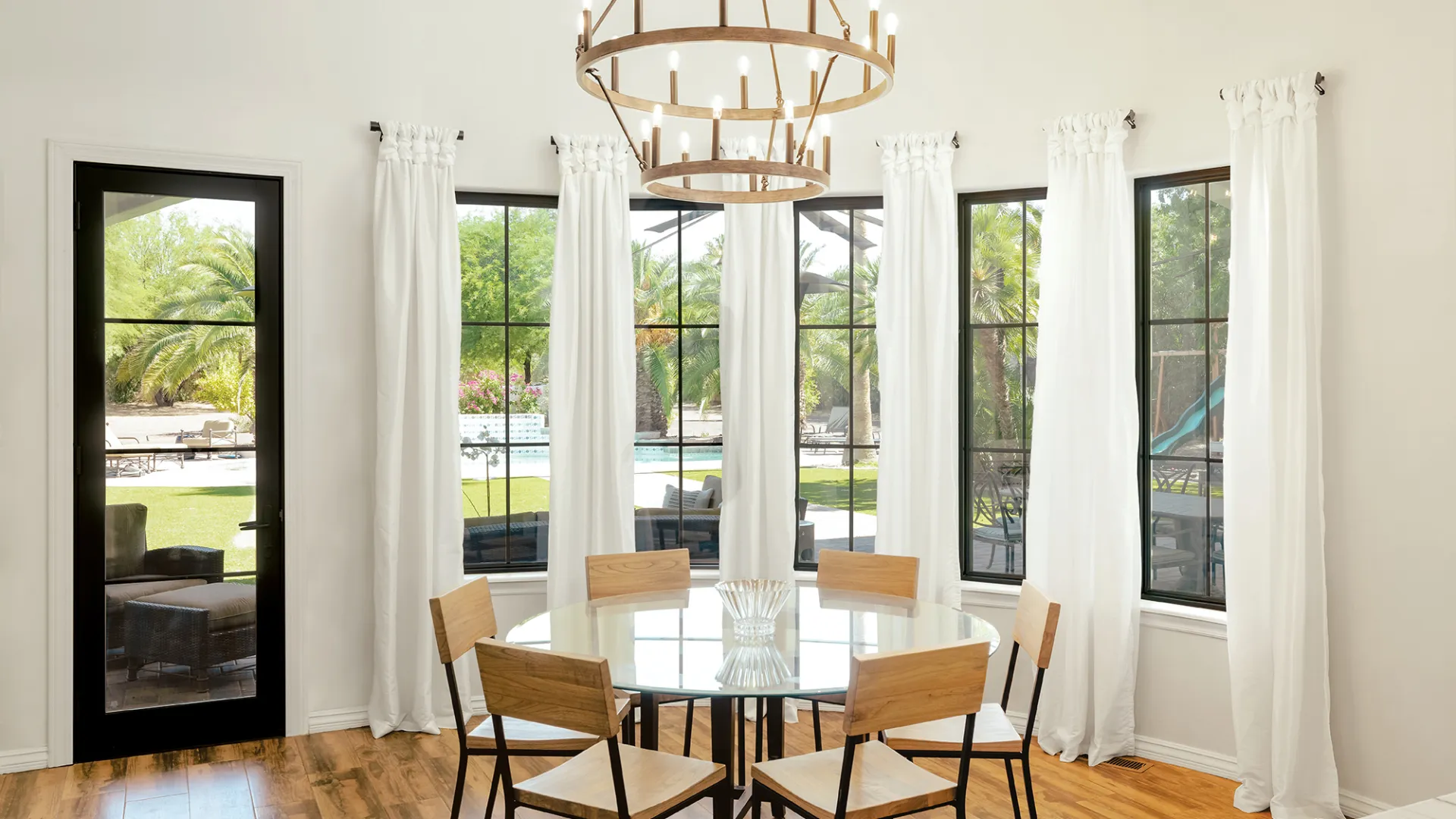 a dining room with a chandelier and a table with chairs
