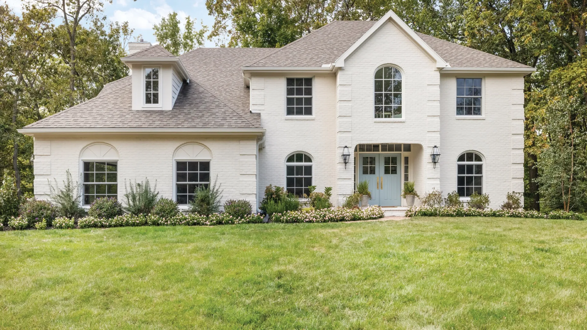 a white house with a lawn in front of it