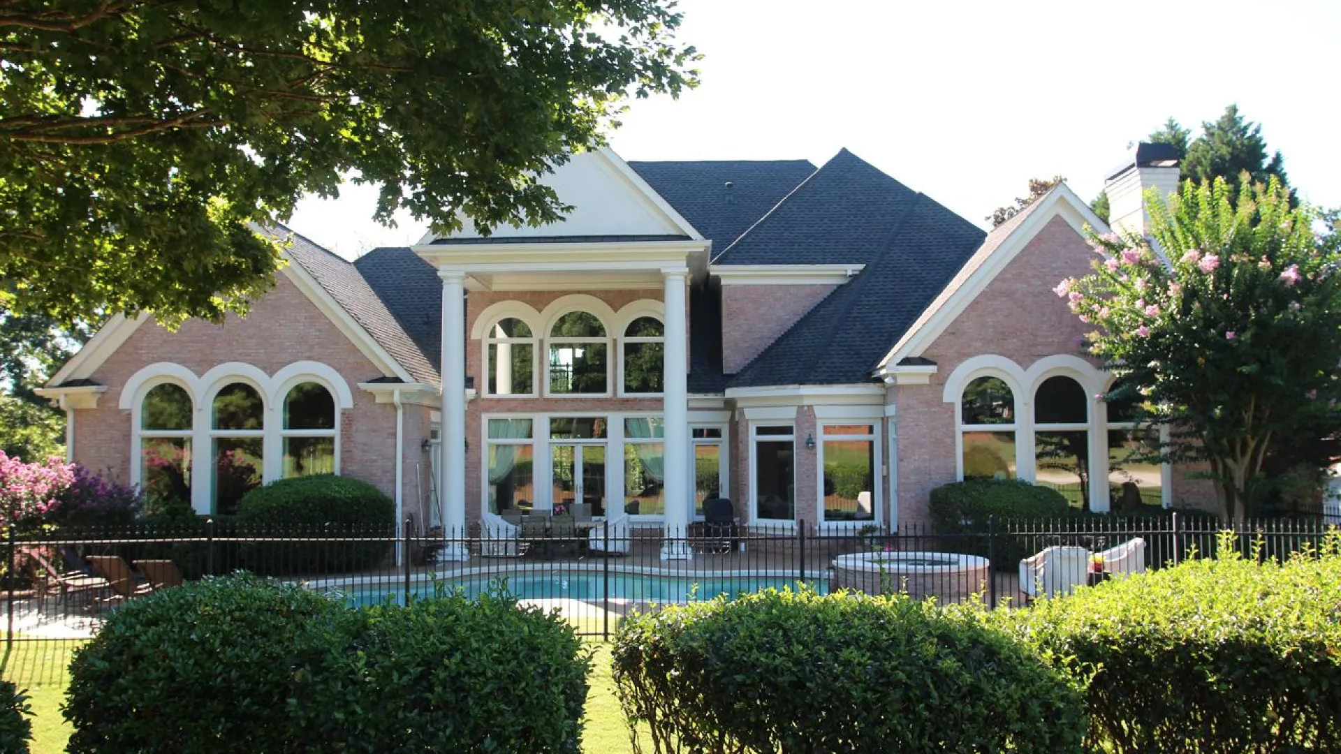 a large house with a fence in front of it