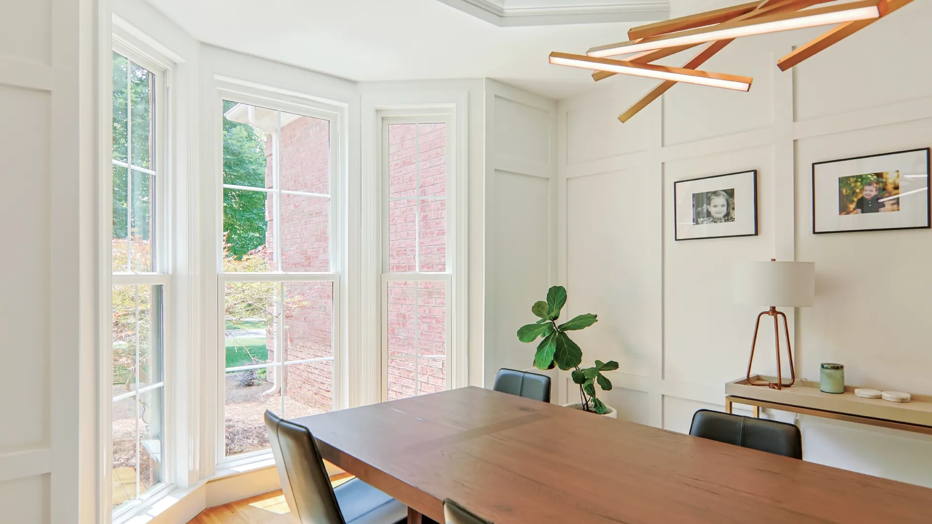 a dining room table with chairs and a plant on it