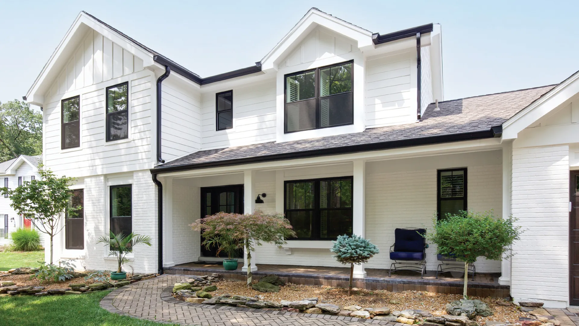 a house with a yard and a chair in the front