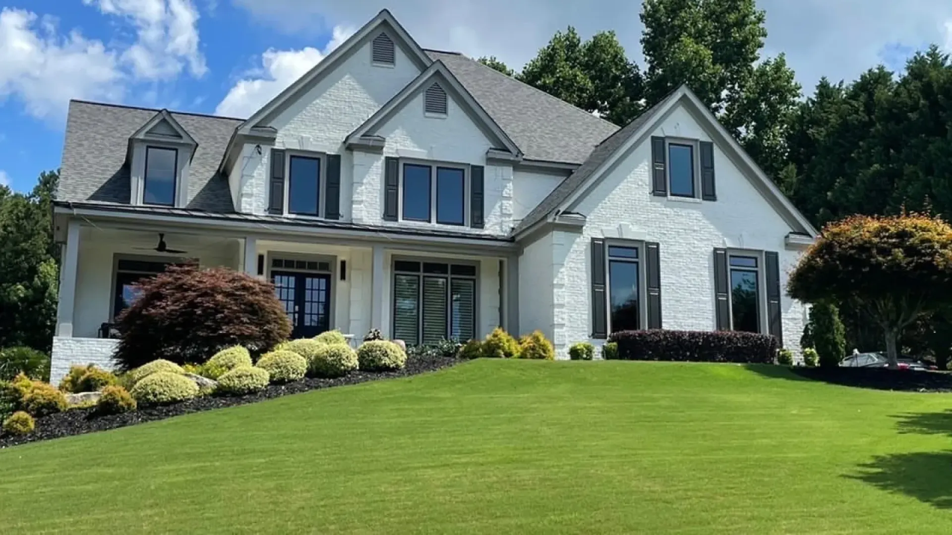 a white house with a lawn
