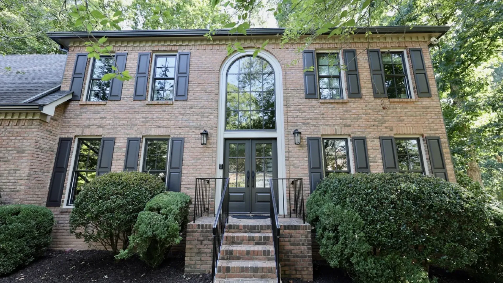 a brick building with a staircase with Owens-Thomas House in the background