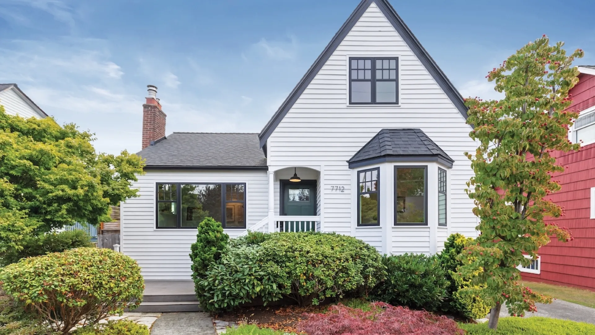 a house with bushes in front of it