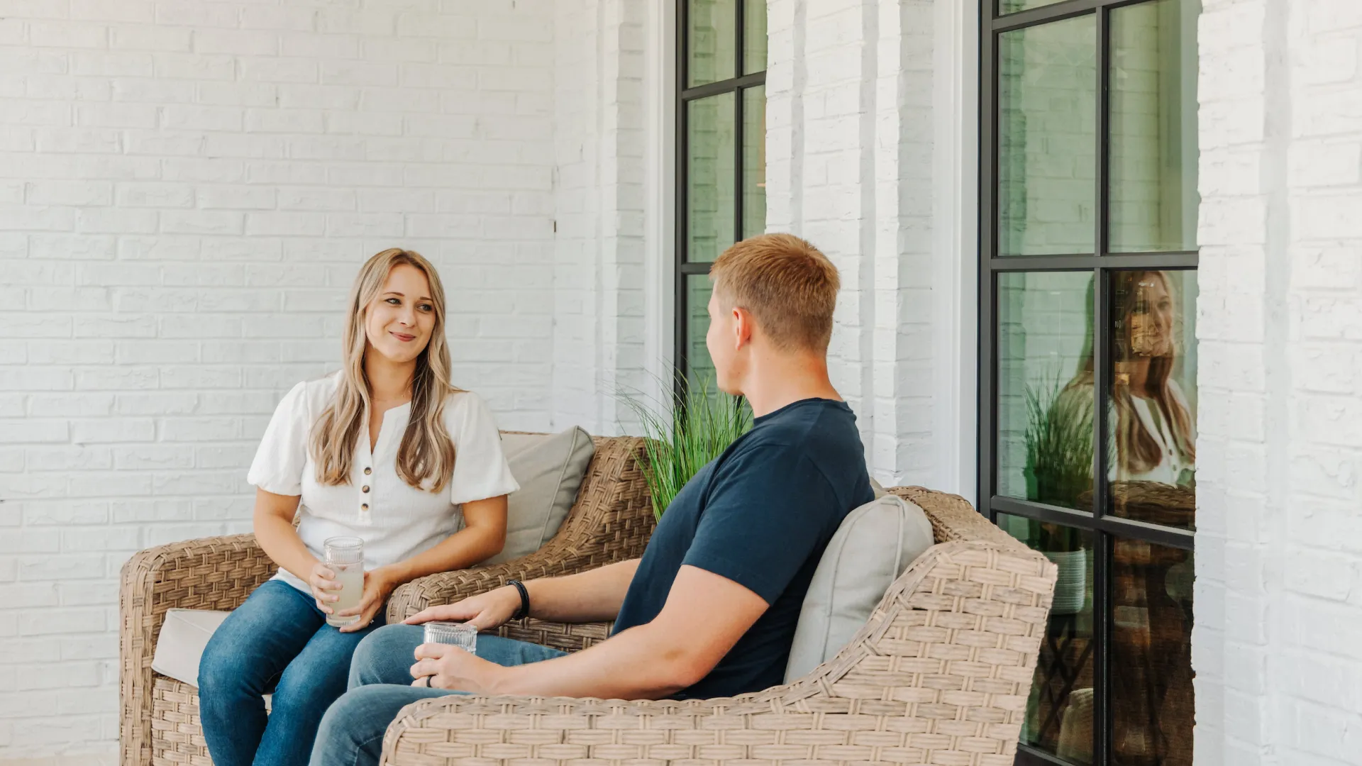 Man and woman sitting on porch in front of Infinity from Marvin brand windows Installed by North Georgia Replacement Windows
