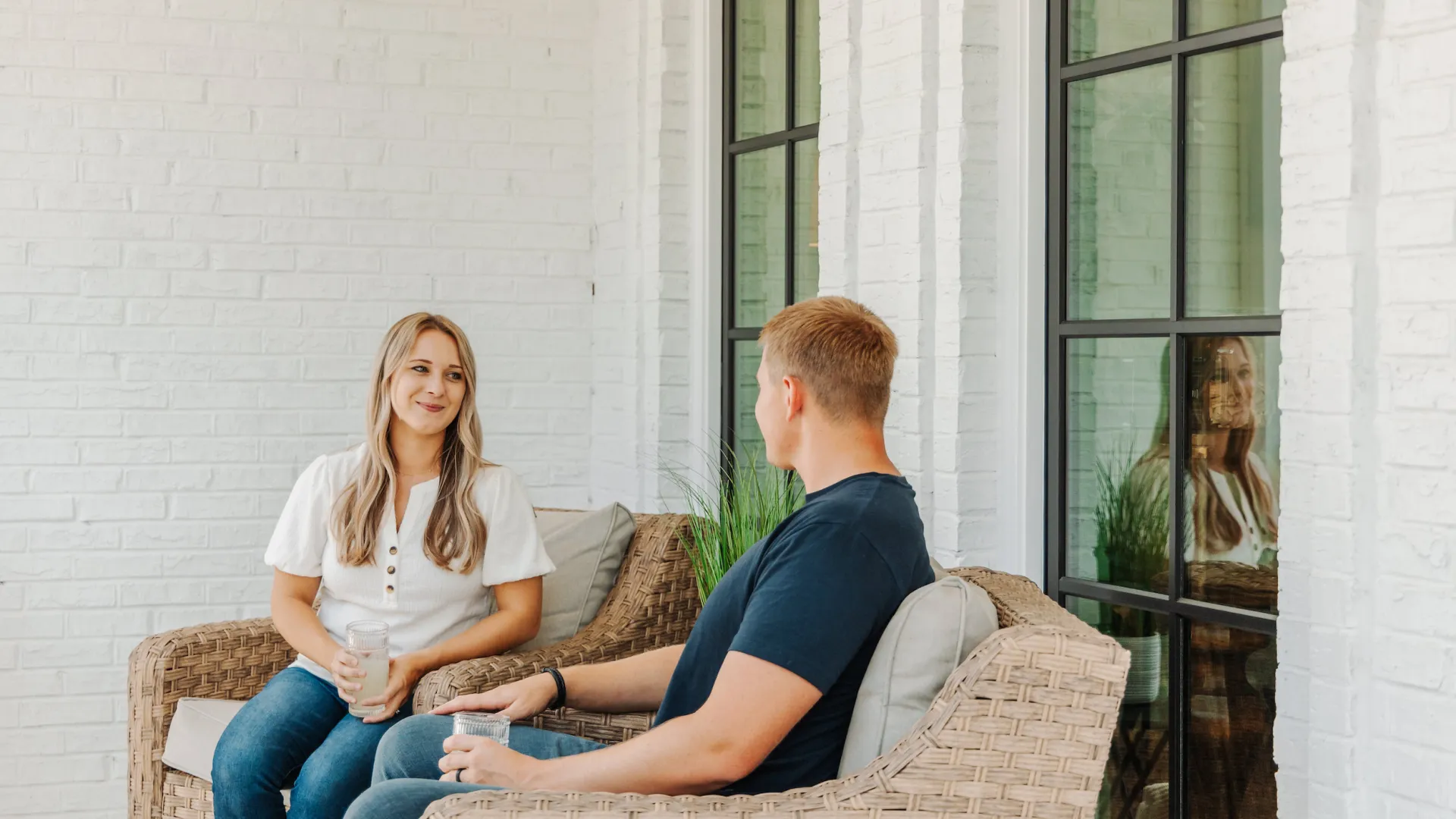Man and woman sitting on porch in front of Infinity from Marvin brand windows Installed by North Georgia Replacement Windows