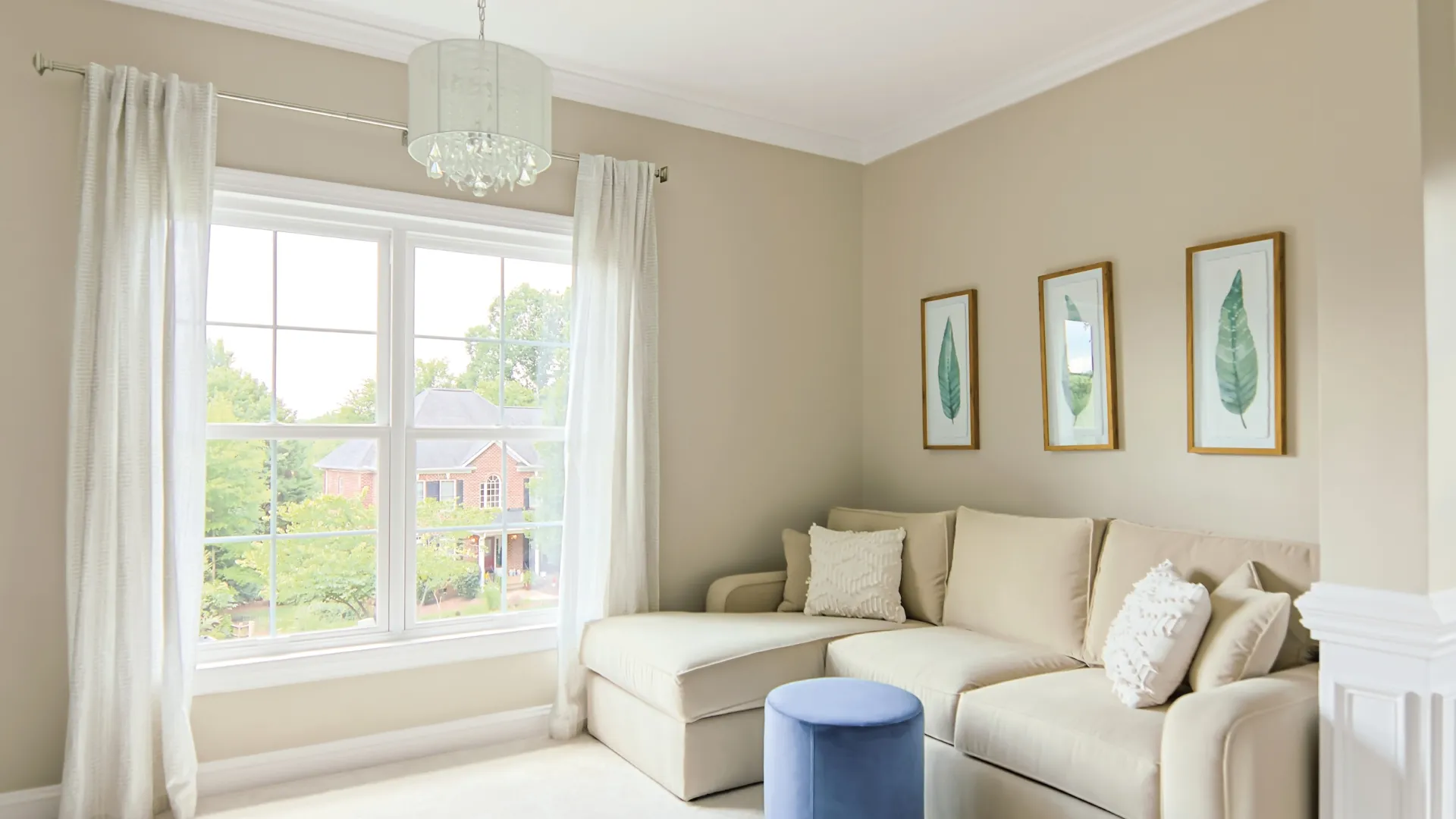 a living room with a white couch and a white table