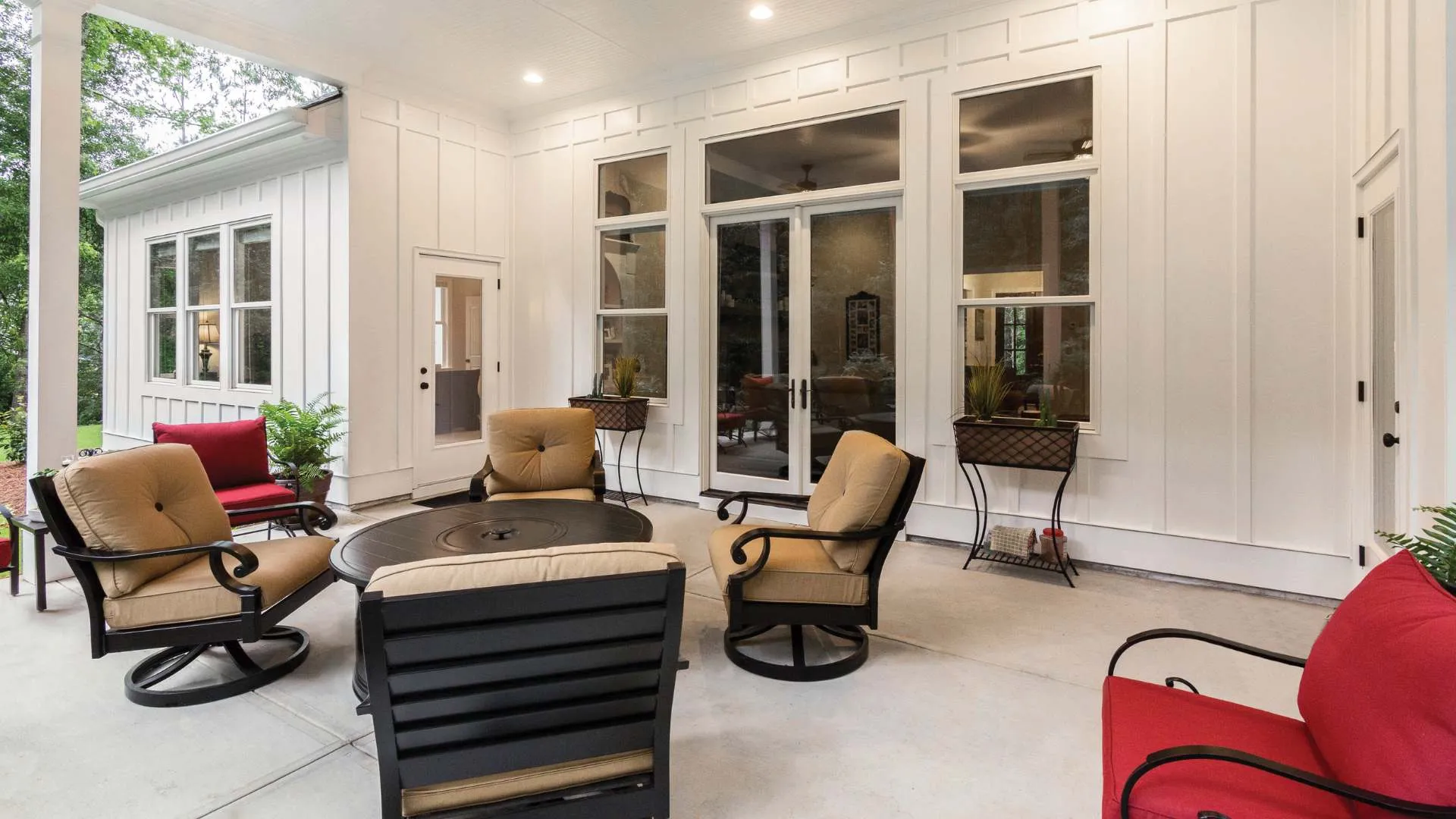 a living room with a large glass door and a large round table