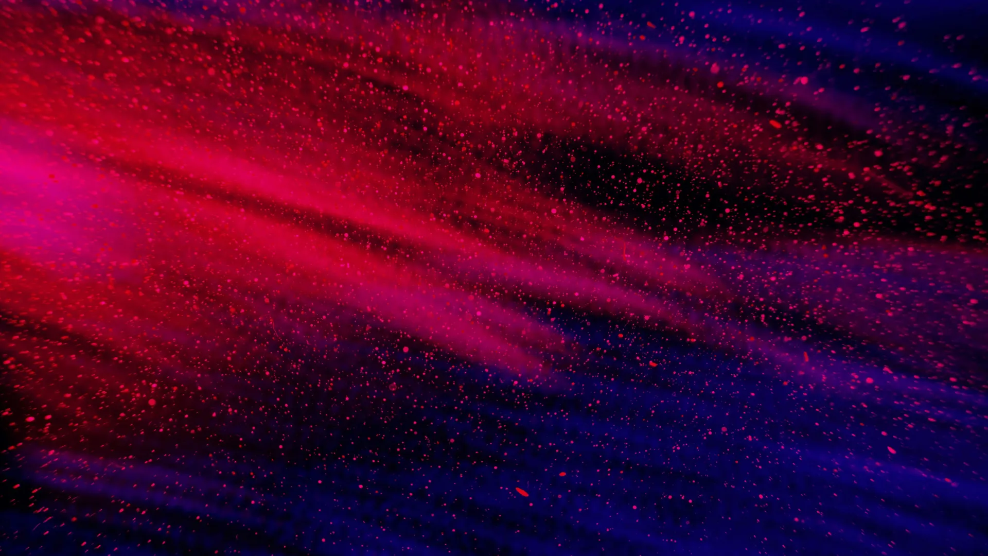 Abstract red and blue particles swirl creating a vibrant cosmic or space-like visual effect.