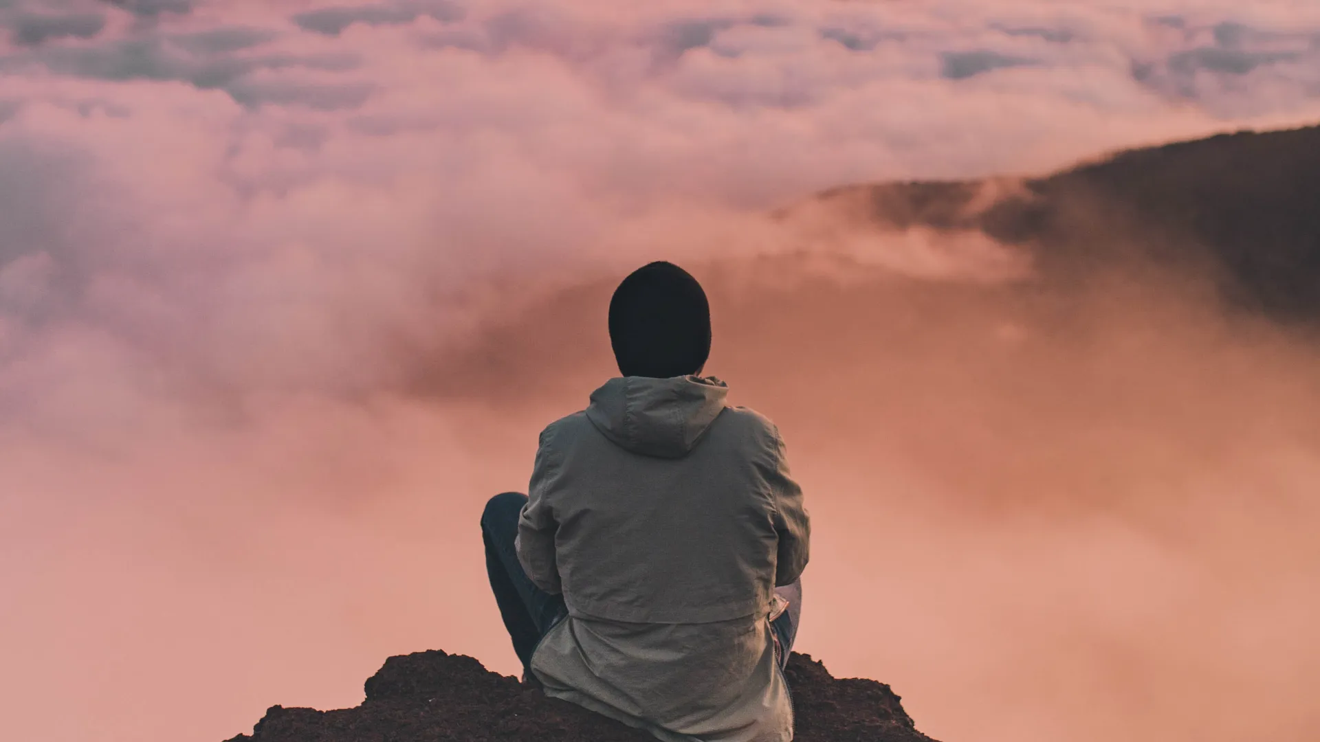 a person sitting on a rock