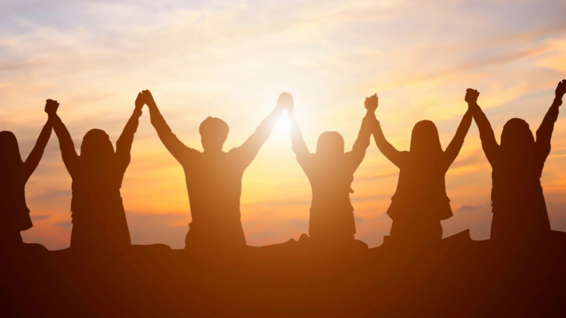 a group of people raising their hands in the air