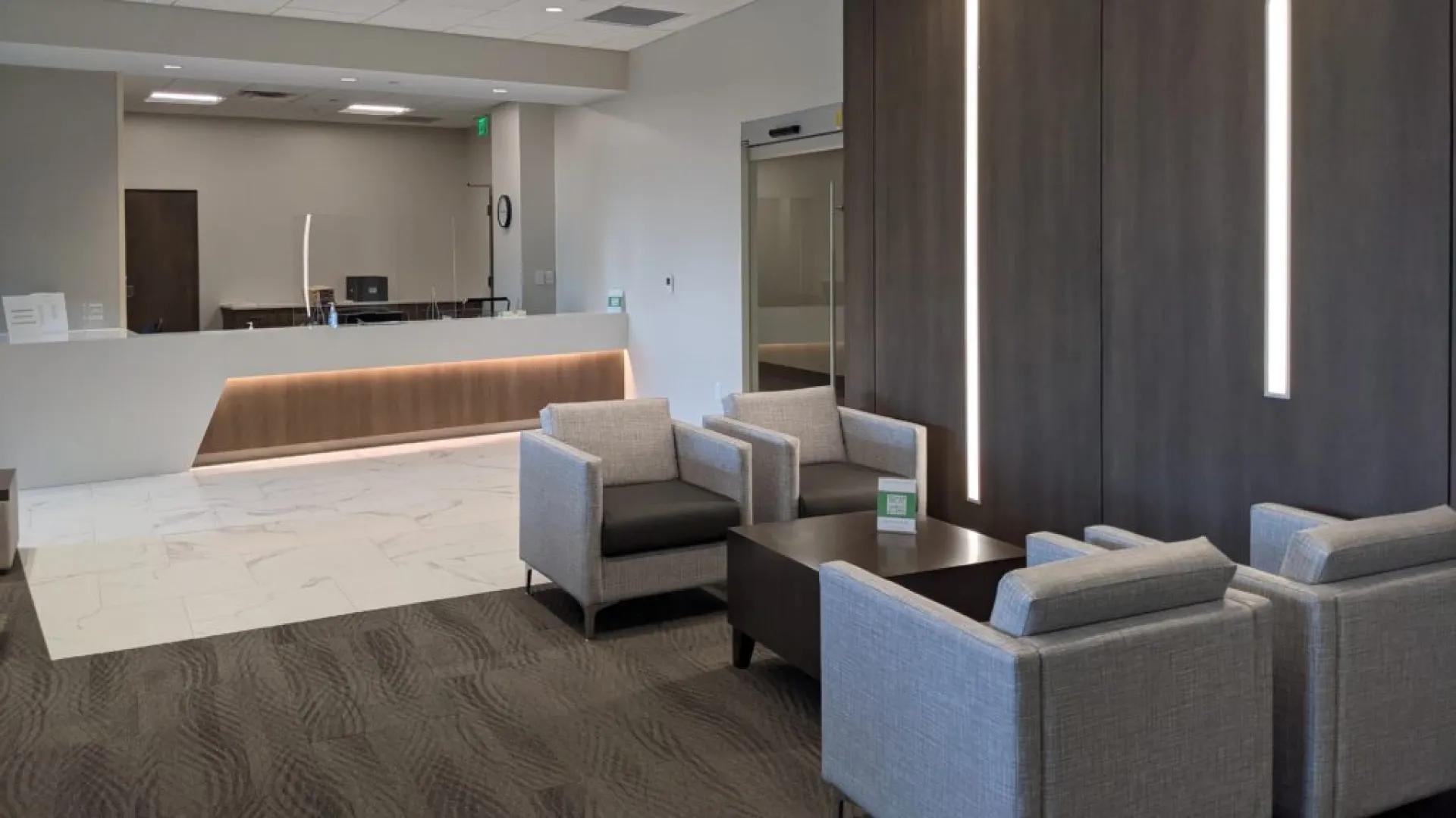 a room with a couch and chairs