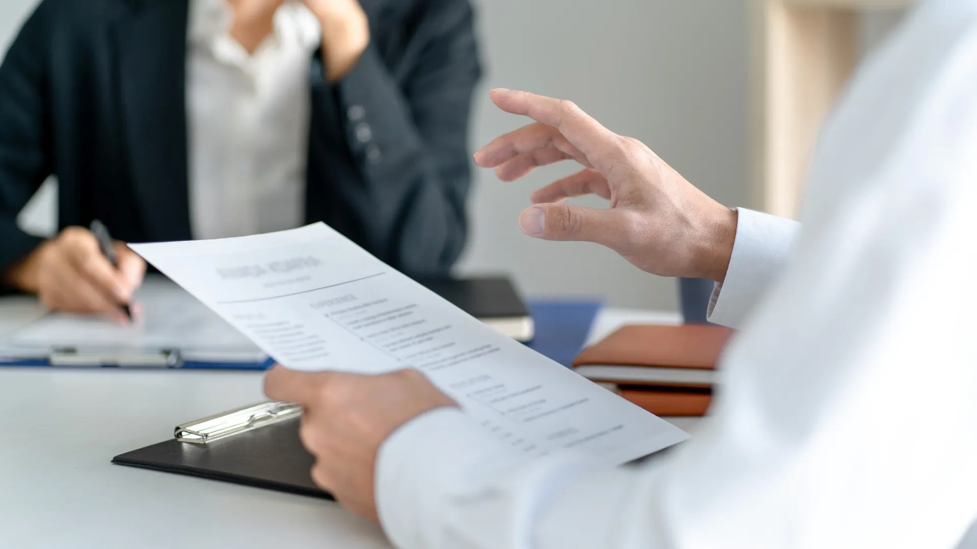 a person signing a paper