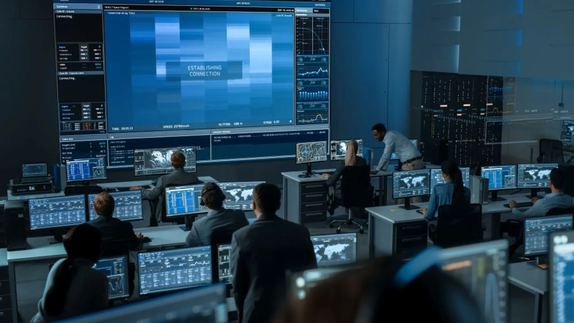 a group of people in a room with many computers