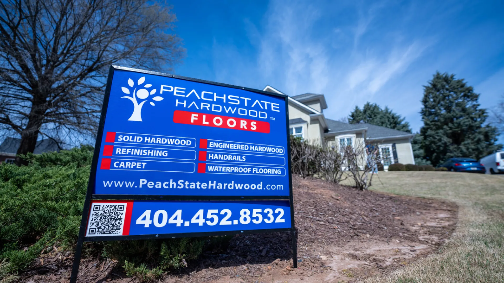 PeachState Hardwood Floors sign advertising hardwood, refinishing, carpet, handrails, waterproof flooring services.