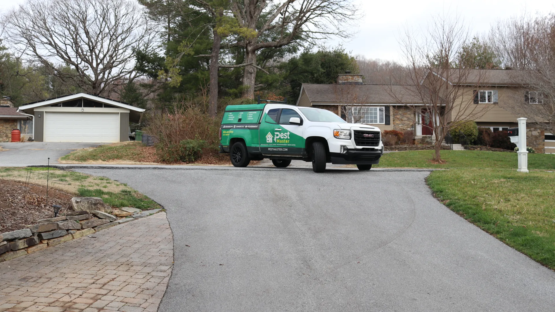 Pestmaster Asheville, NC pest control services truck in a neighborhood