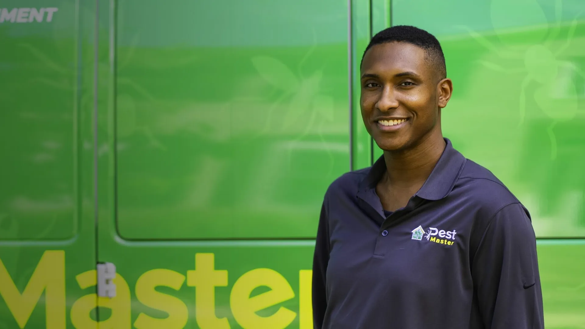 Sherlen Archibald smiling in front of a green screen