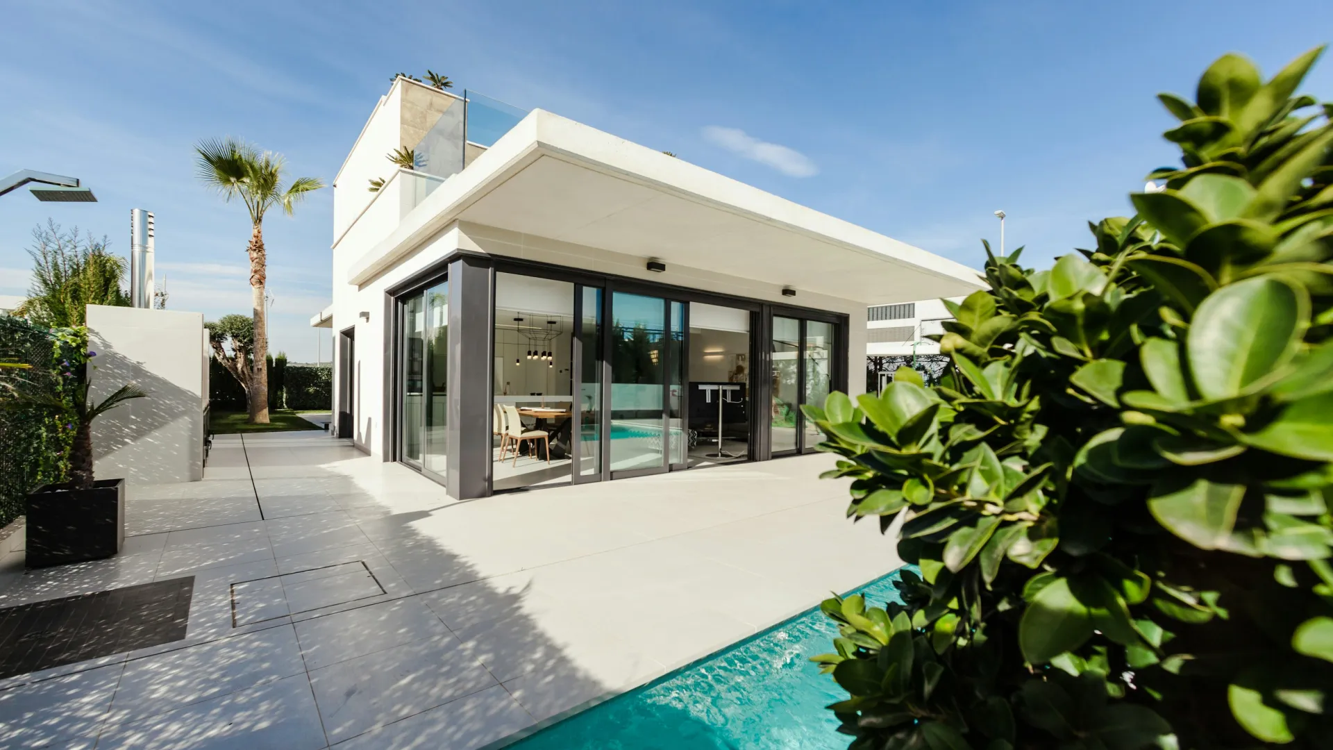 Modern house exterior pest nation treatments with large windows, pool, pest control and mosquito service