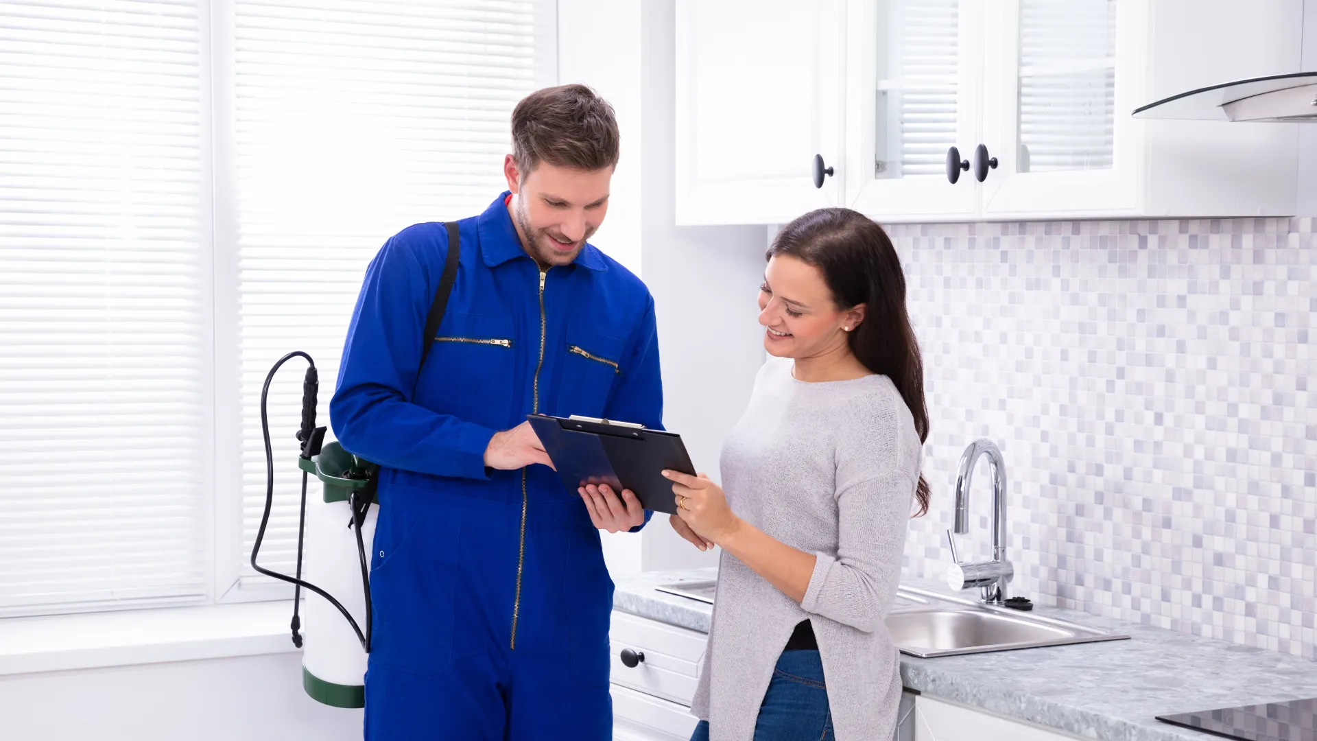 a man and a woman looking at a tablet