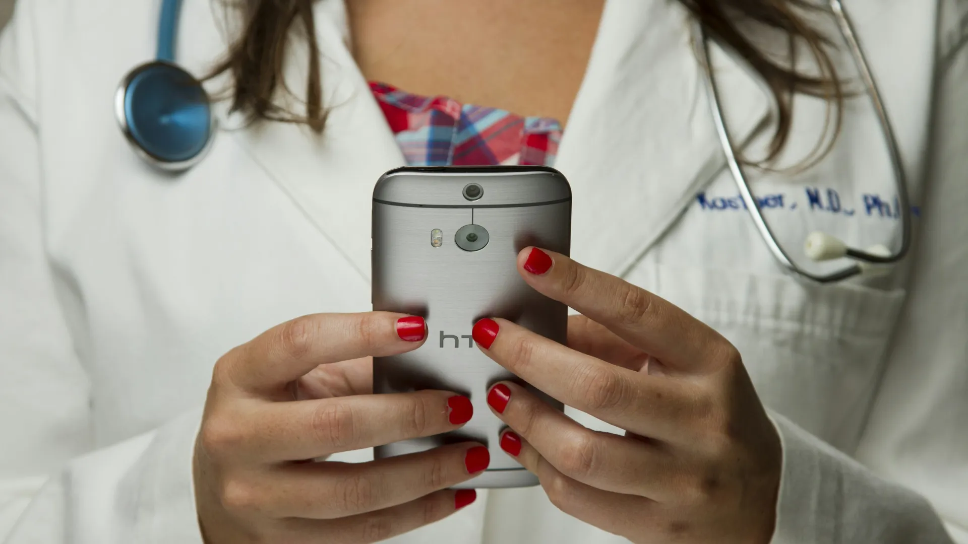 a doctor using a stethoscope to check a patient's blood pressure