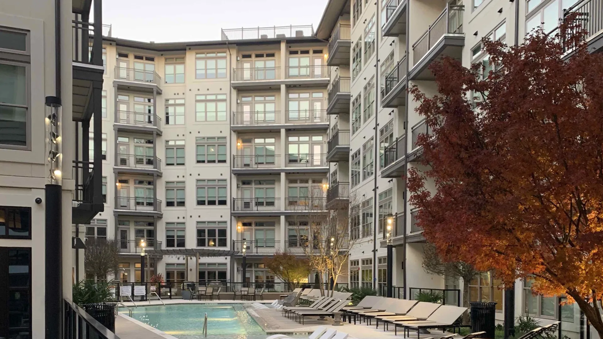 a pool in a courtyard between buildings