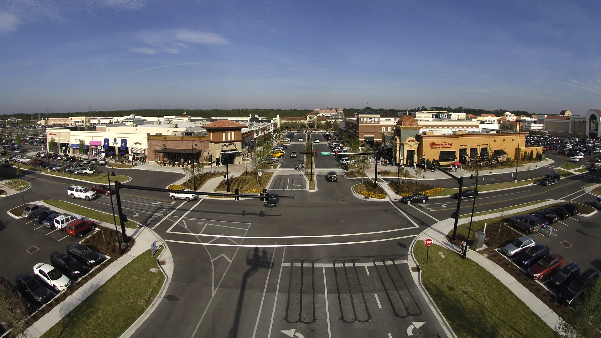 an overhead view of an intersection and shopping area