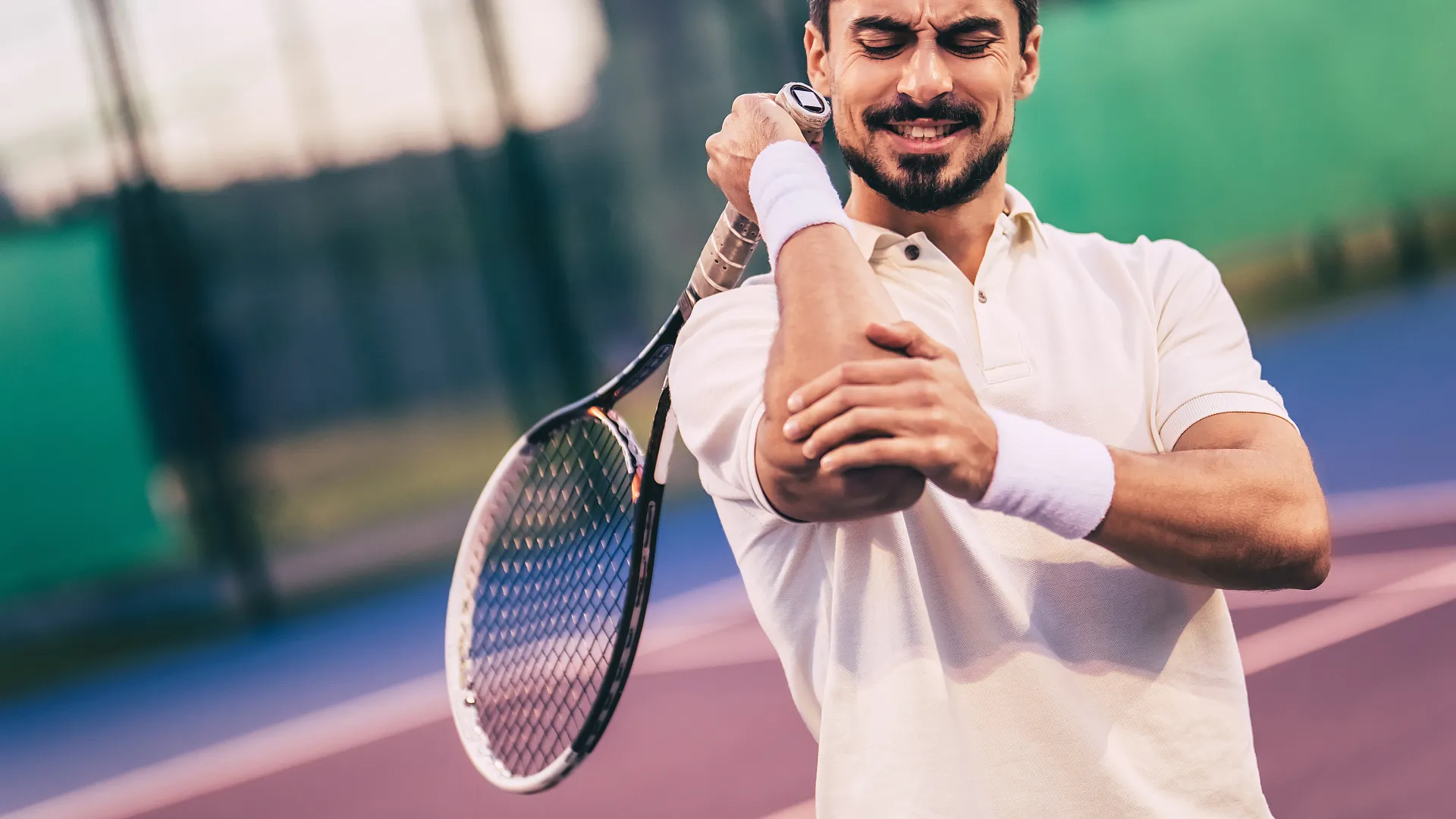 Doctor applying a white elastic bandage cast to a patient's arm for injury support and care.