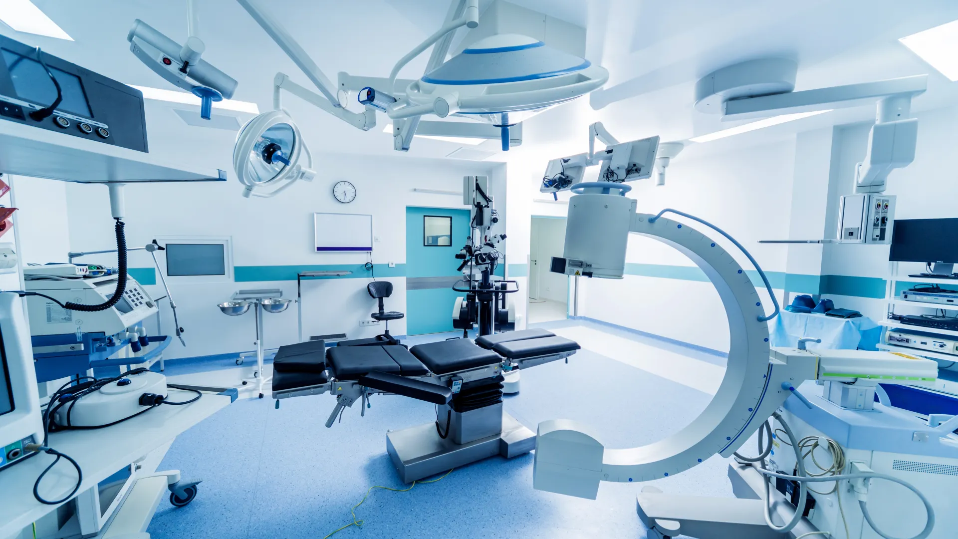 Modern hospital operating room with surgical lights, monitors, and advanced medical equipment ready for procedures
