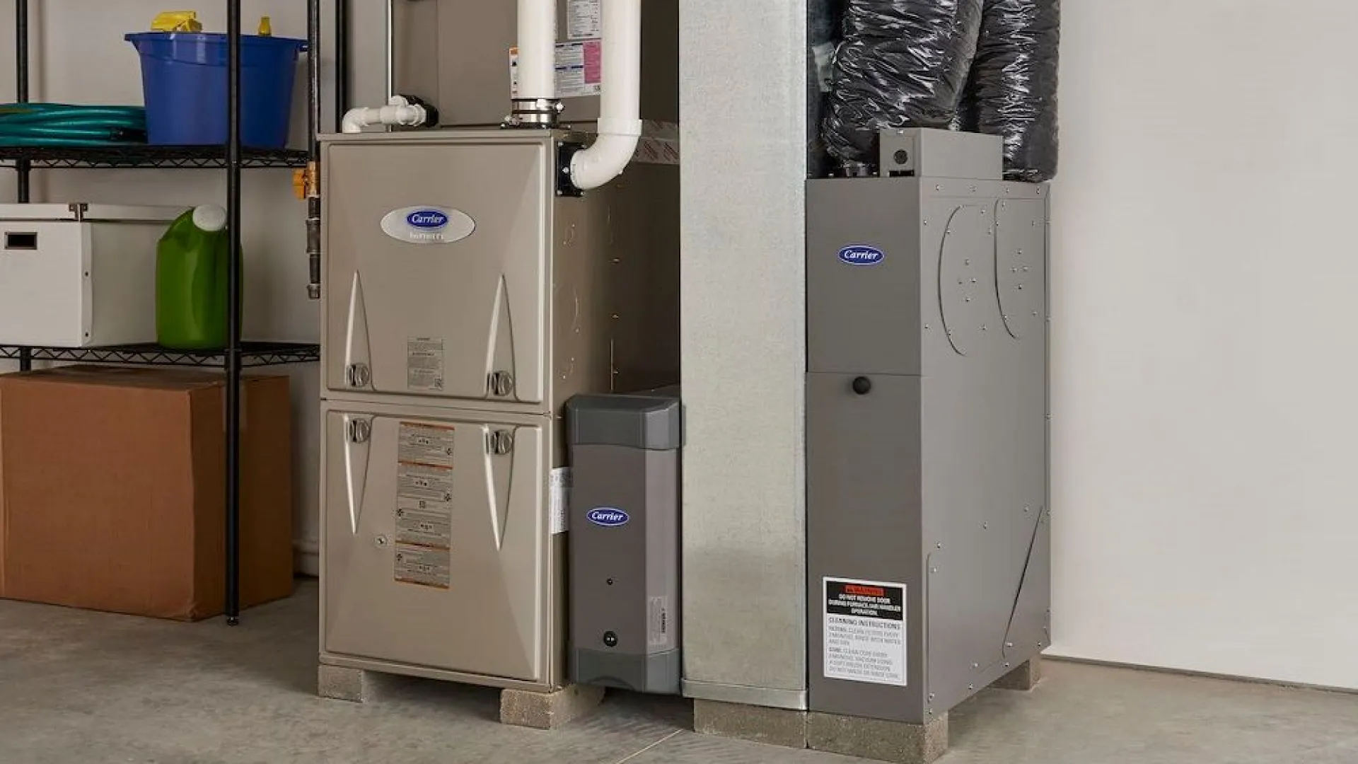 A modern furnace and air conditioning unit in a clean garage space with organized storage shelves.