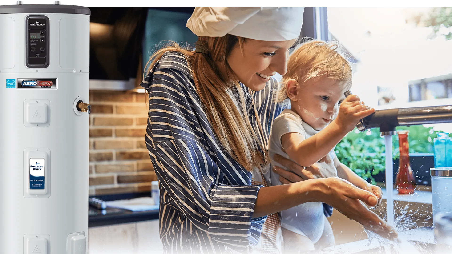 A mother helps her toddler wash hands at a kitchen sink with a modern water heater in the background.