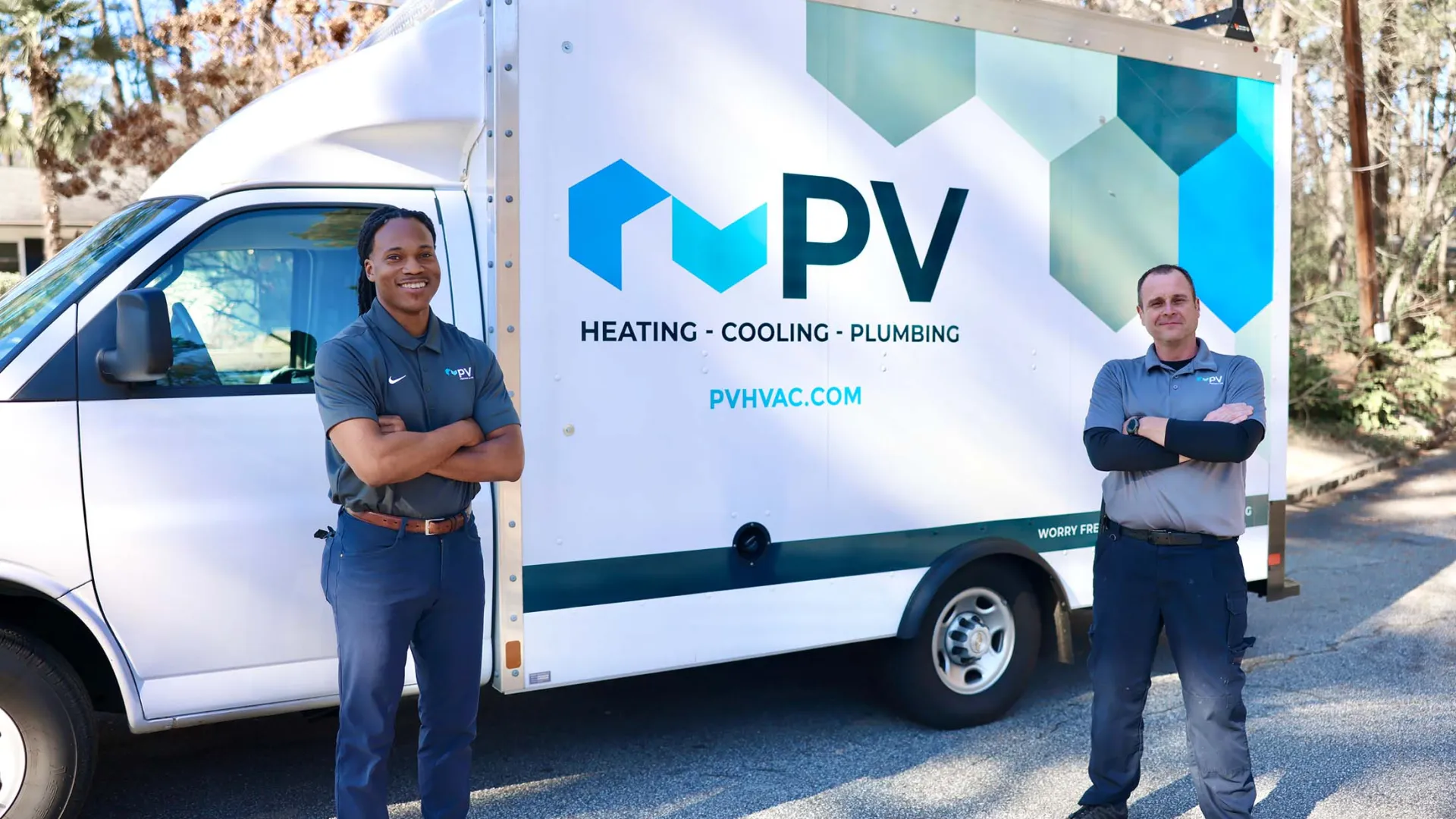 a couple of men standing next to a white truck