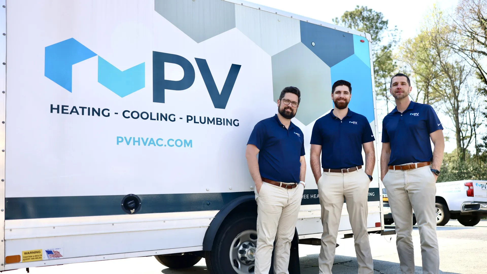 a group of men standing in front of a truck