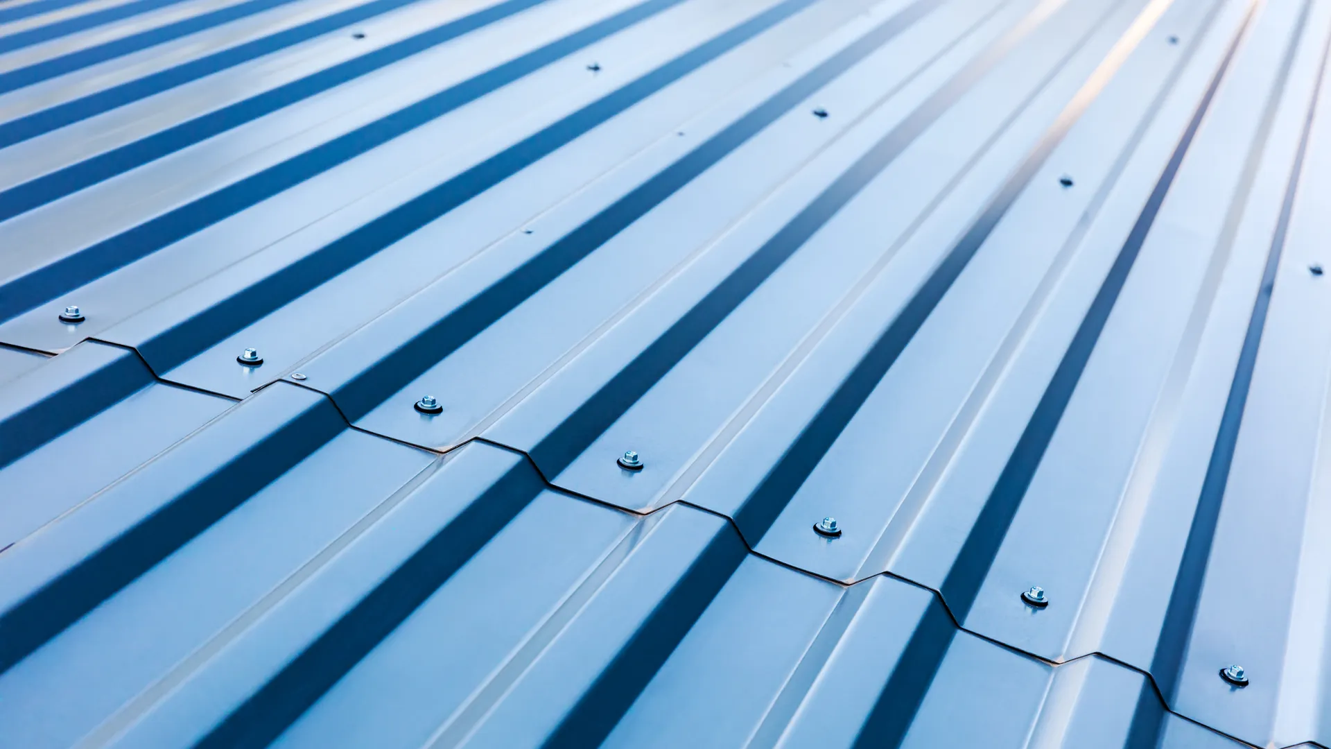 Close-up of wooden shingles arranged in uniform rows showing natural grain and color variations.