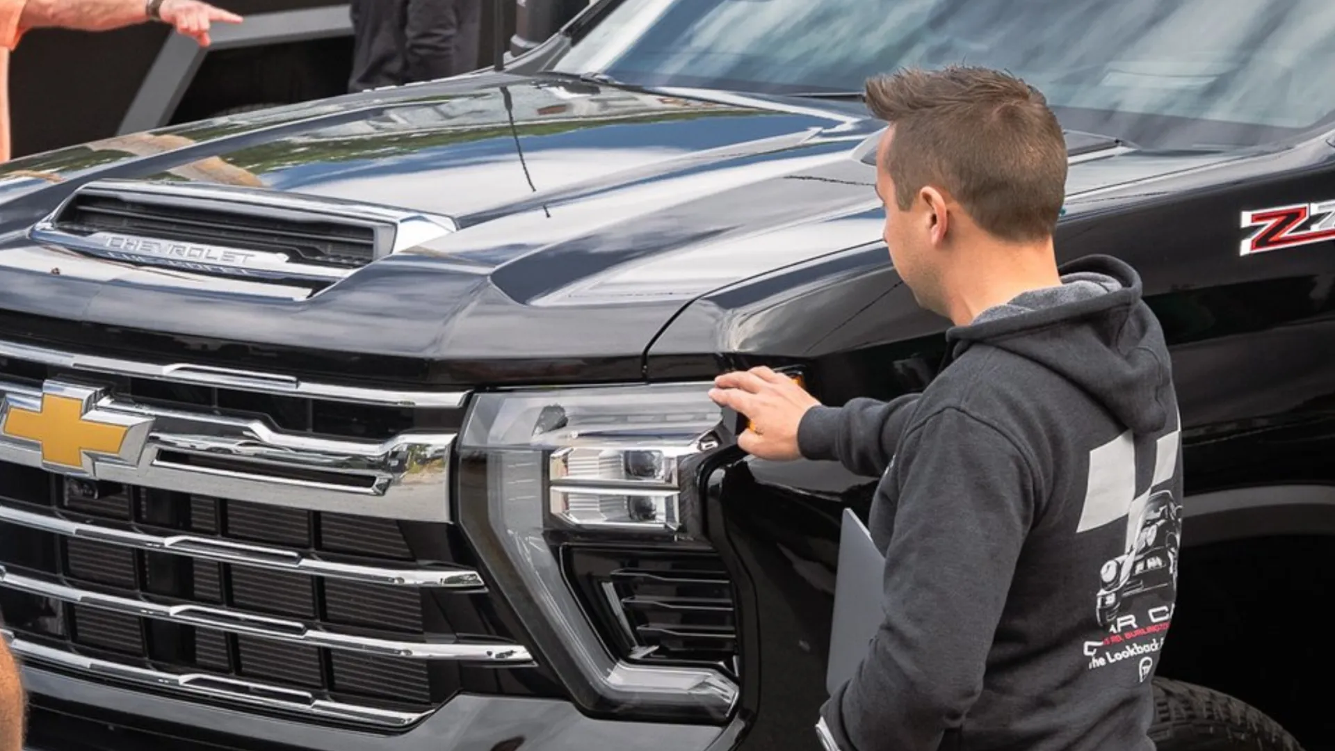 a person standing next to a car