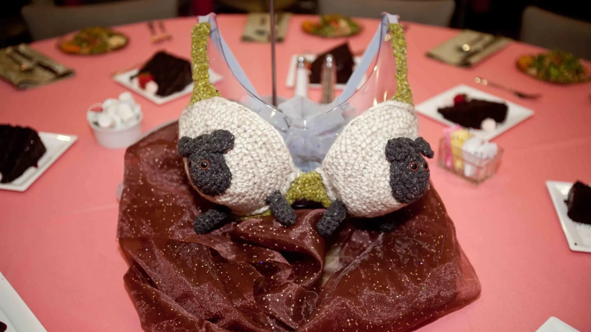 a cake with a white frosting and decorations on a red table