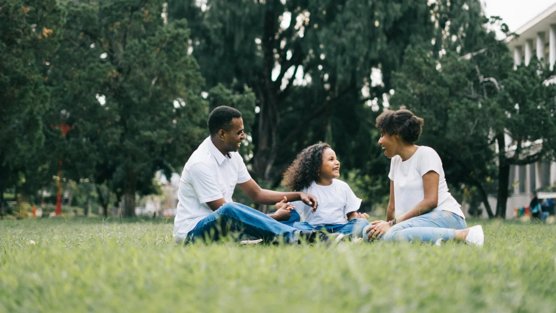 a family sitting on the grass