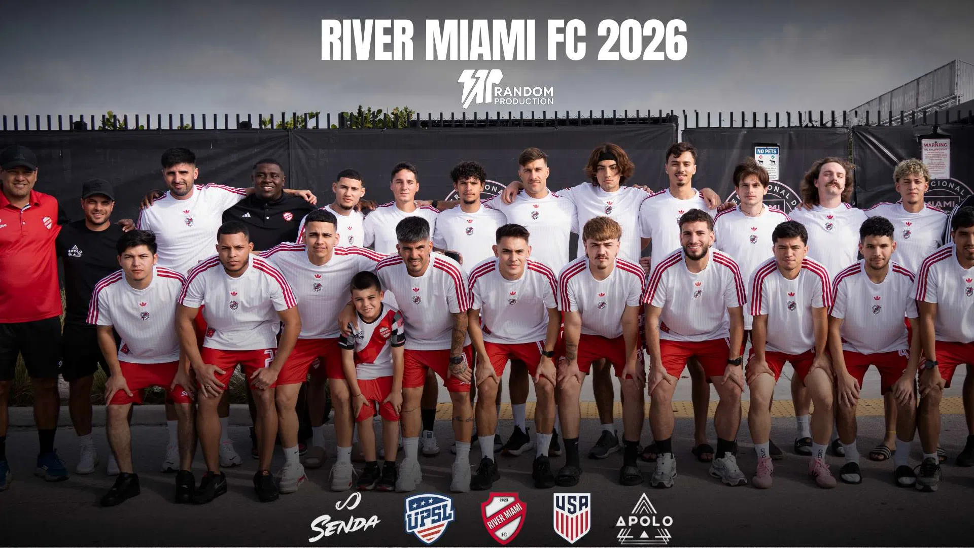River Miami FC 2026 soccer team posing in white and red uniforms with coaches in front of stadium seating.