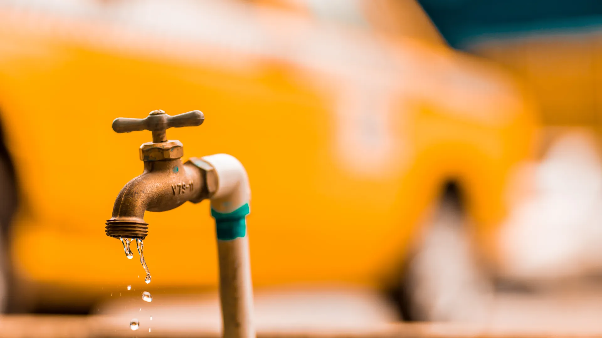 an outdoor faucet pouring water into a sink