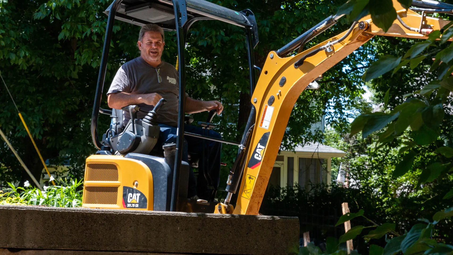 a man driving a yellow tractor