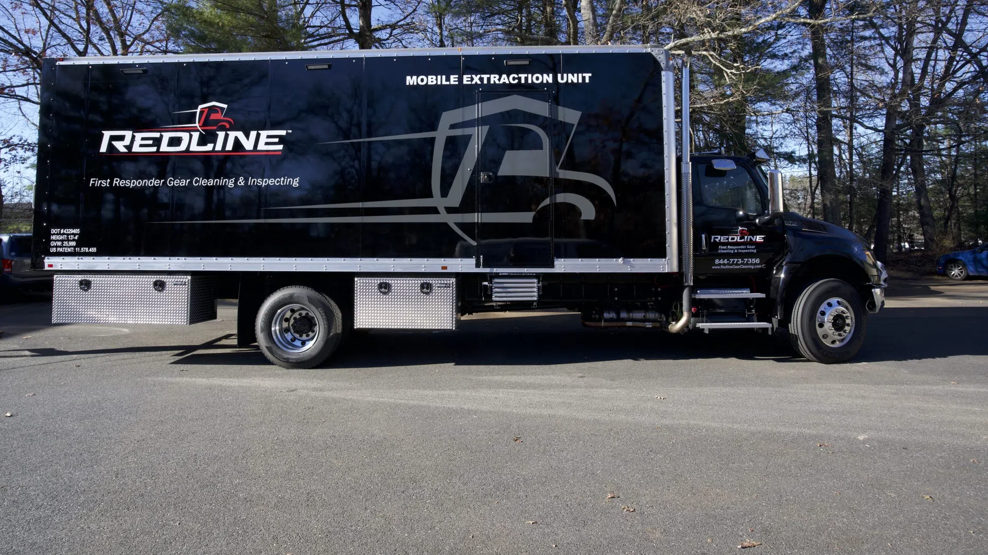 Black Redline mobile extraction unit truck for first responder gear cleaning and inspecting parked outdoors.